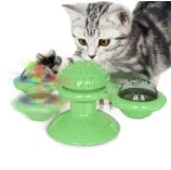 Cat playing with rotating windmill toy featuring suction base and luminous ball