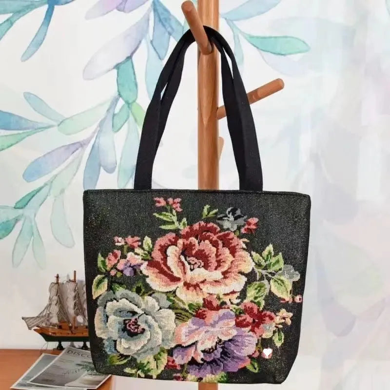 Colourful embroidered canvas shoulder bag with gold wire handles shown in small, medium, and large sizes.