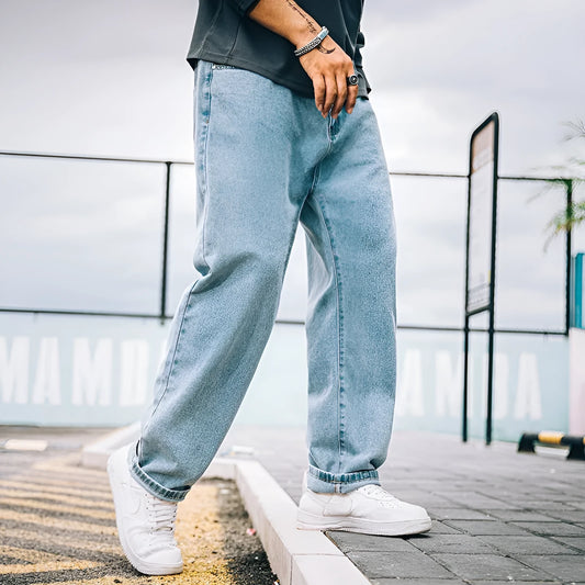 Men's dark blue loose straight fit cotton jeans with a zipper fly, shown on a hanger.