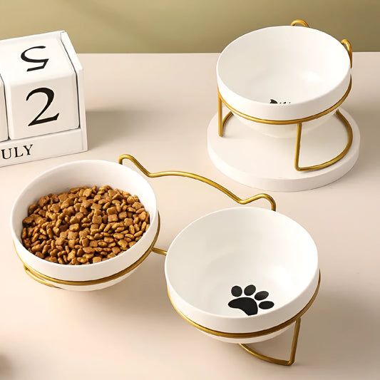 White ceramic pet bowl with cat paw design on a black iron frame raised feeder.