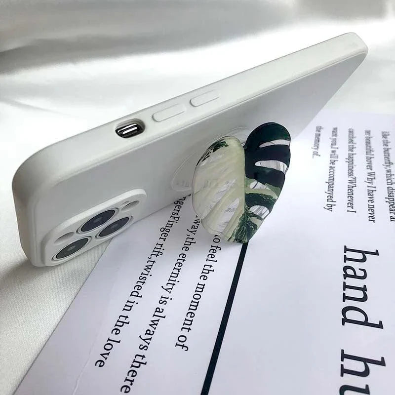 Stylish leaf-inspired smartphone stand with secure grip and adjustable viewing angle for hands-free use