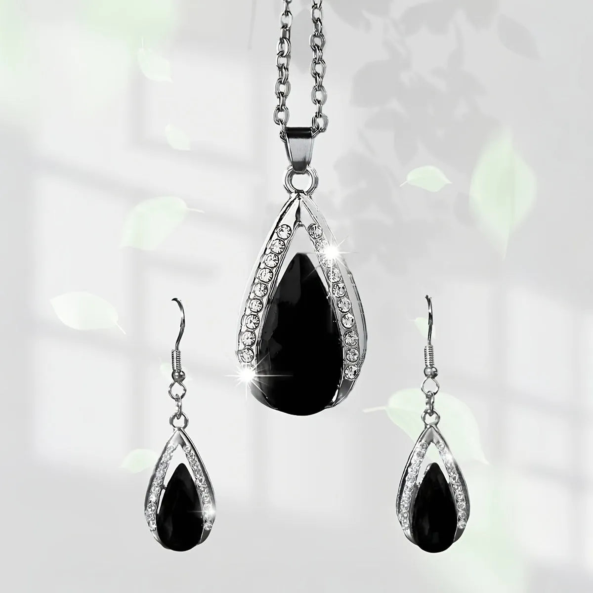 Black red teardrop glass pendant necklace and earrings suite with water droplet design elements on alloy jewellery