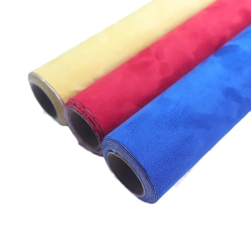 Rolls of self-adhesive leather suede in multiple colours showing texture and adhesive backing.