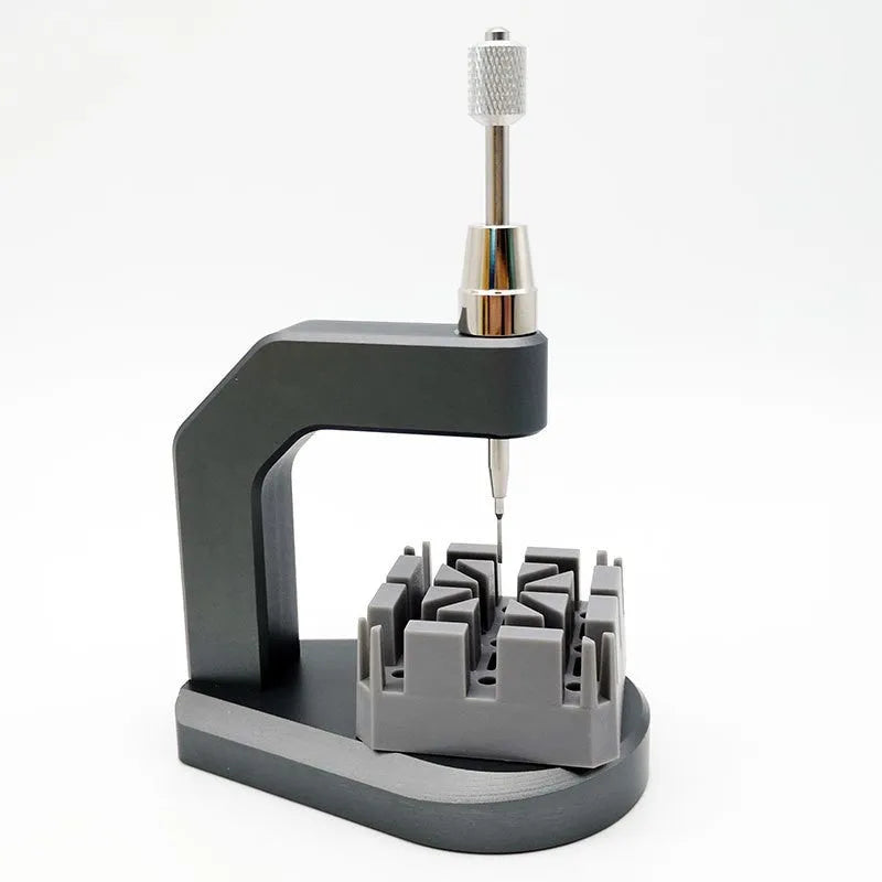 Silver multi-purpose press strap removal tool made from tool steel.
