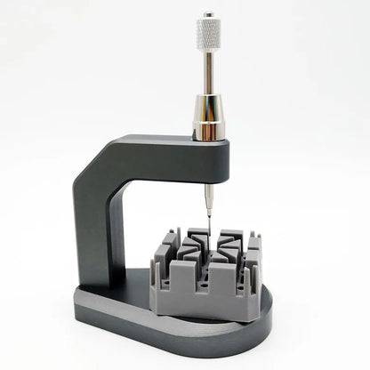 Silver multi-purpose press strap removal tool made from tool steel.