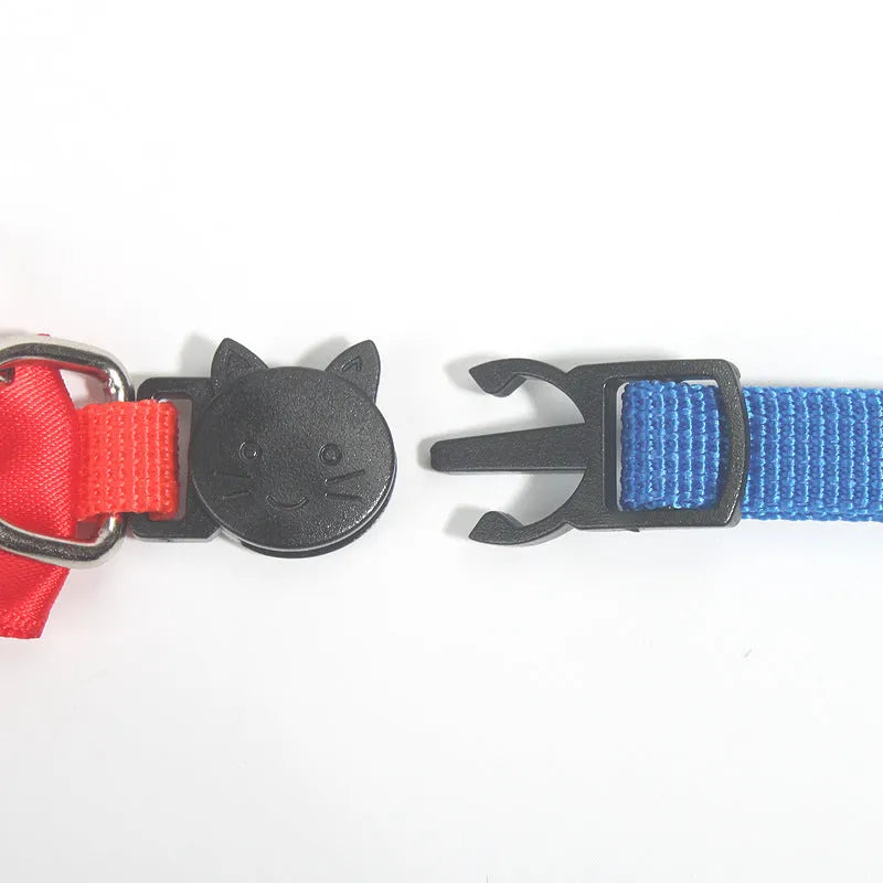 Striped nylon cat collar with decorative bow and bell in multiple colour options on a white background.