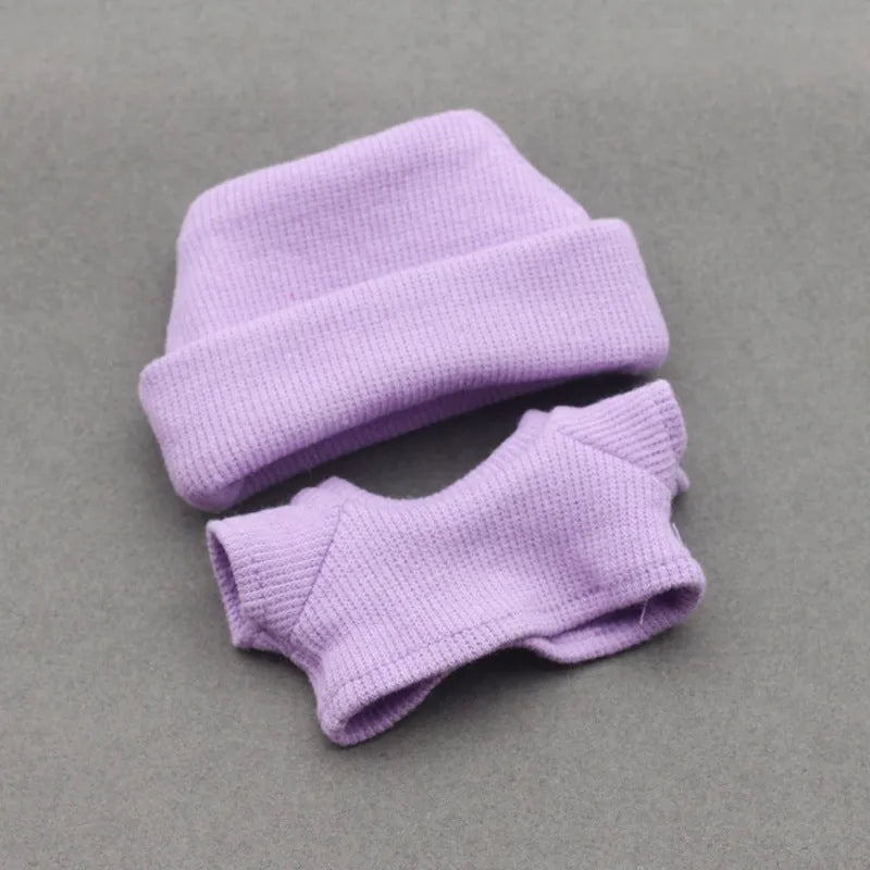 Doll clothes set with knitted flanging hat and T-shirt in multiple colours including pink, white, and stripes.