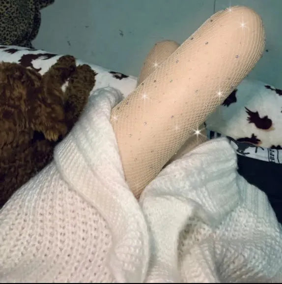 Women's fishnet stockings in skin colour, black, and white, showing thin nylon mesh texture and free-size fit on leg.