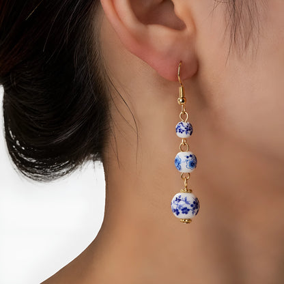 Long retro earrings with blue and white porcelain ceramic beads and geometric alloy construction