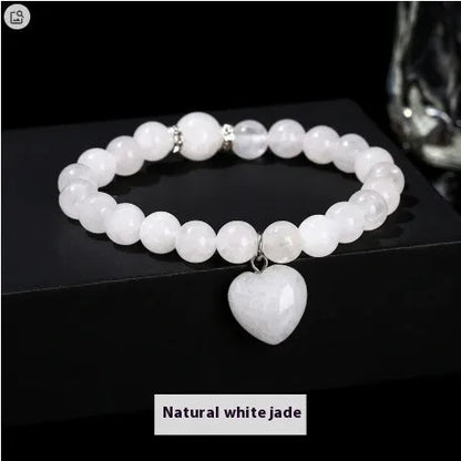 Handmade women's bracelet with natural gemstone beads and a silver love pendant charm.