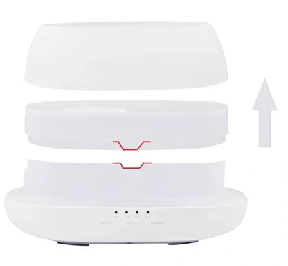 White HOMEFISH aroma diffuser with colour-changing LED light displaying blue hue, remote control beside unit