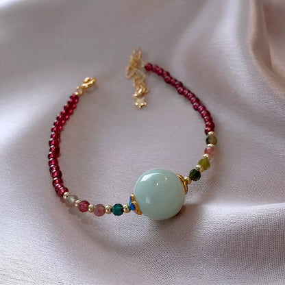 Aquamarine coloured drop shape tourmaline bracelet with garnet electroplated finish