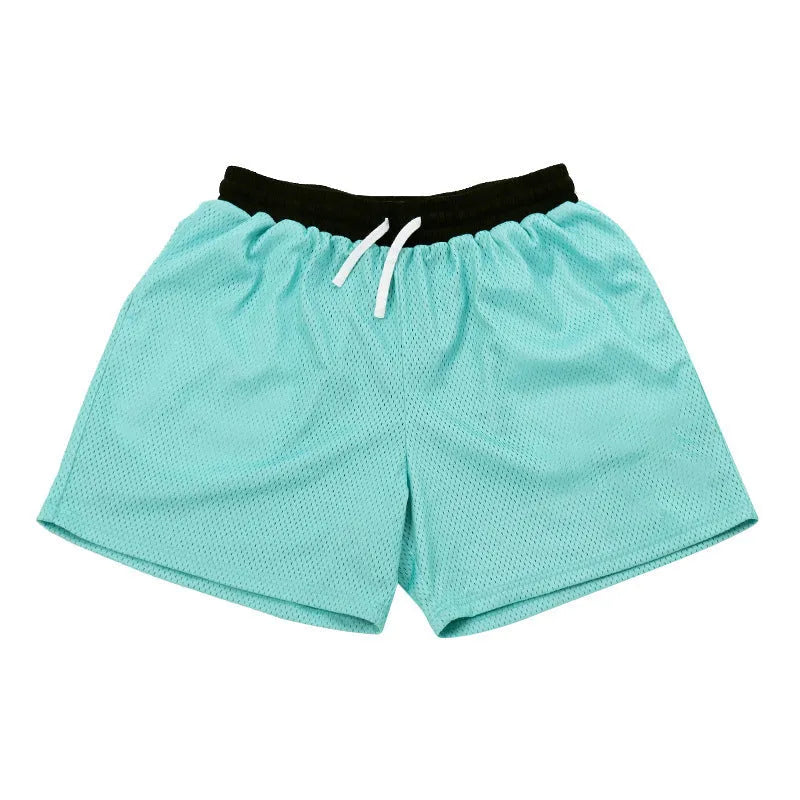 Men's black athletic shorts with grey mesh side panels for breathability, laid flat on a surface.