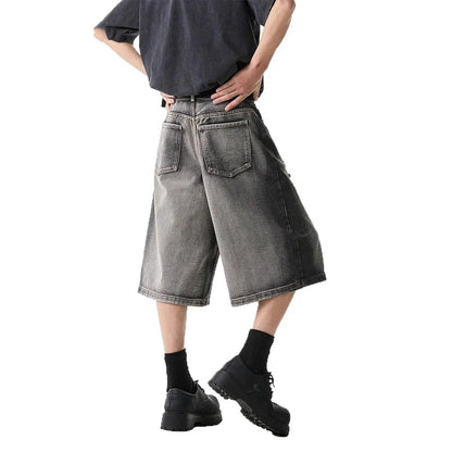 Grey women's denim shorts with distressed holes and water washed finish, loose cropped fit