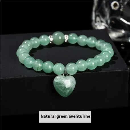 Handmade women's bracelet with natural gemstone beads and a silver love pendant charm.