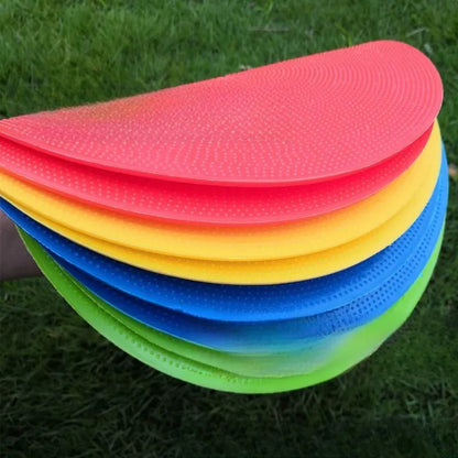 Soft yellow TPE football landmark pad disc on grass, 23 cm diameter.