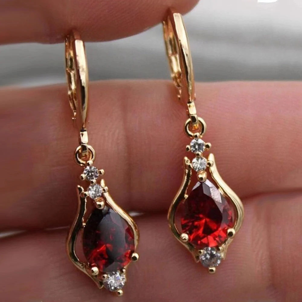 Elegant drop-shaped earrings with shimmering zircon accents in various colors, including purple, white, red, pink, and champagne