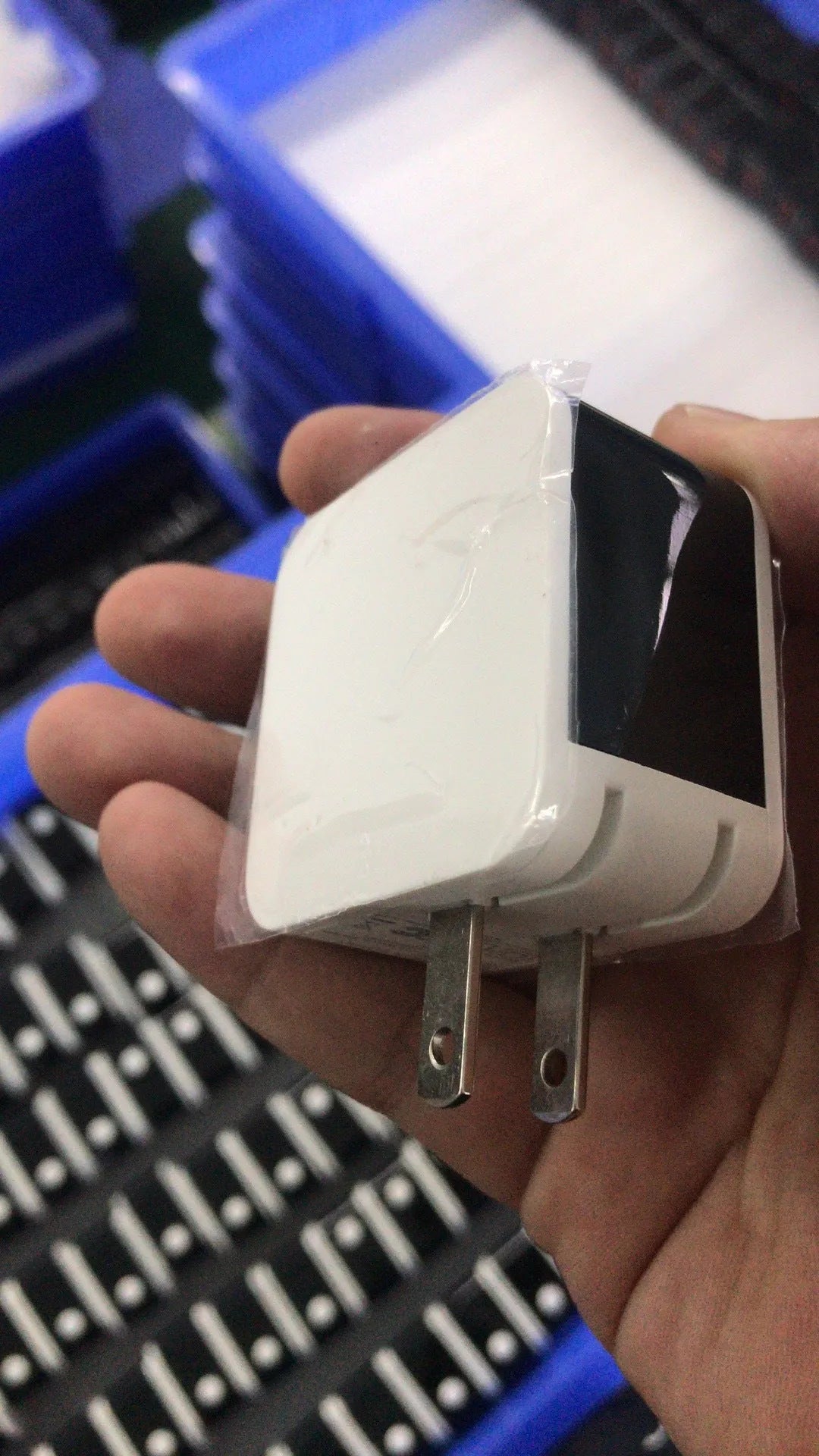 Black dual USB fast charger with digital voltage display showing 5V output and foldable UK plug