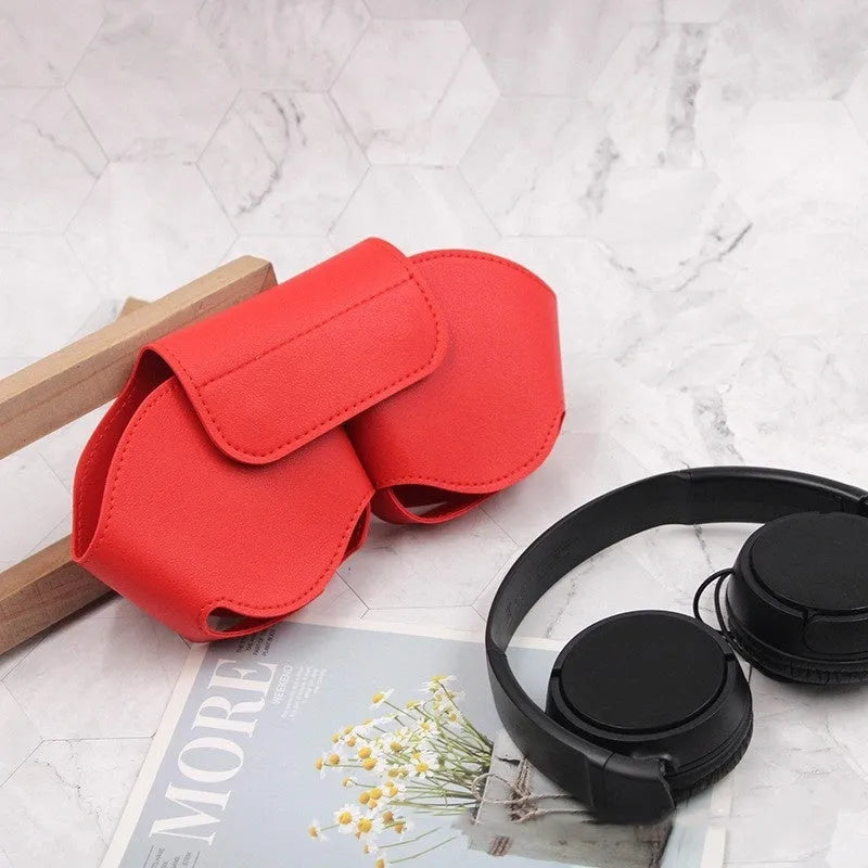 Black PU leather protective case for Apple AirPods Max headphones on a table.