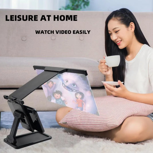 Black mobile phone screen amplifier with detachable holder, magnifying to 12 inches, folded for portability