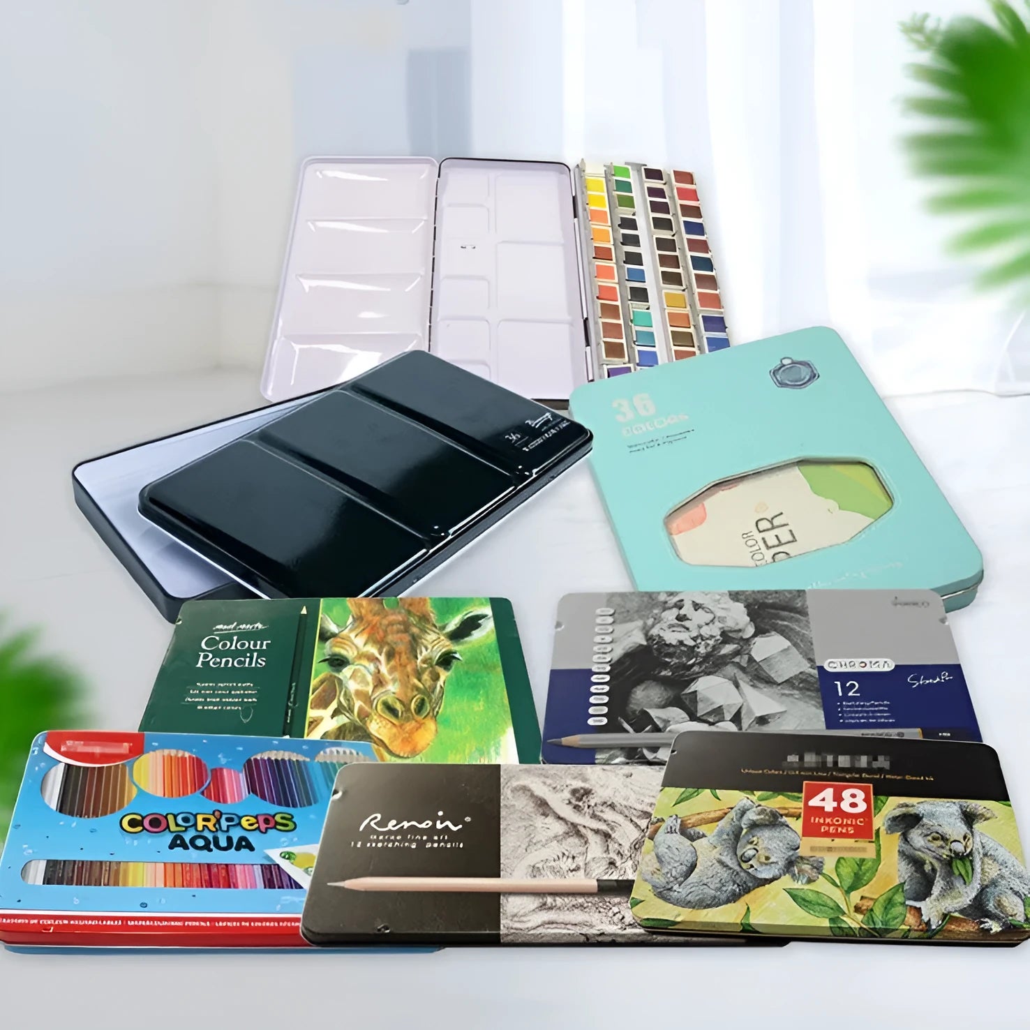 Tinplate solid watercolour paint box in square shape with folding lid, shown in three size options.