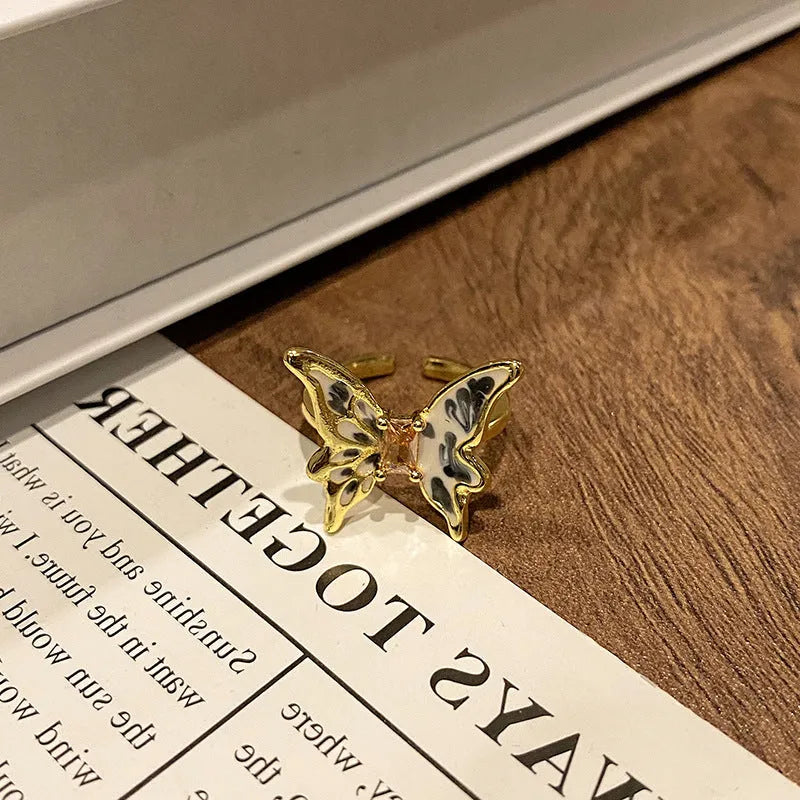 Copper women's ring with Chinese butterfly design and adjustable open loop.