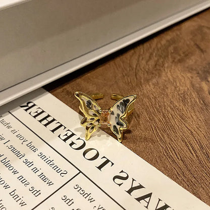 Copper women's ring with Chinese butterfly design and adjustable open loop.