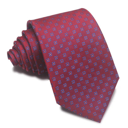 Close-up of a red and black striped jacquard weave tie with an arrow tip, showing texture.