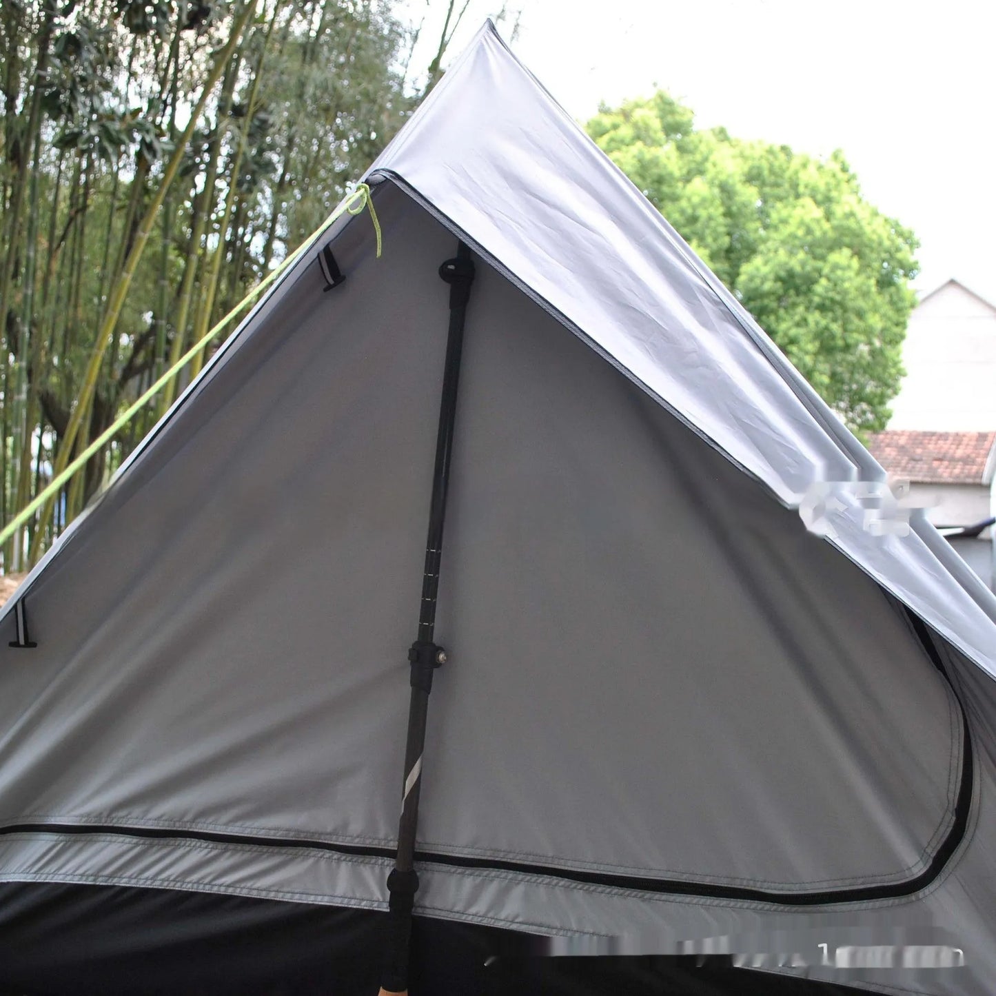 Brown and white portable A-line camping tent set up with hiking poles, showing its spacious interior for 2-3 people.