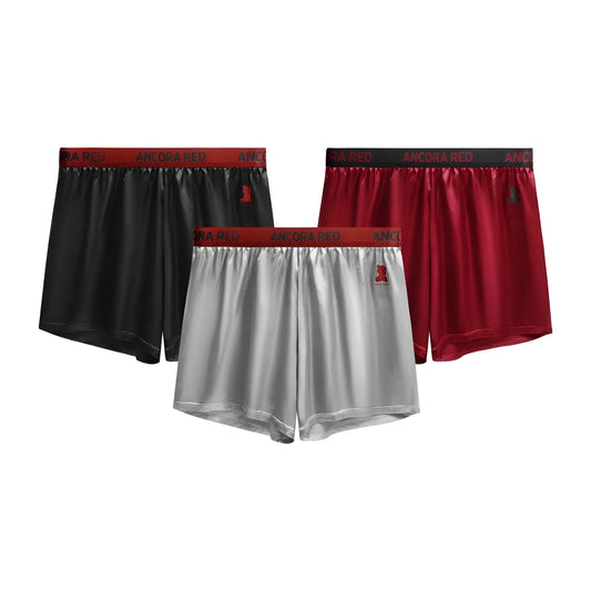 Men's solid black knitted polyester boxer briefs with a mid-waist band, laid flat on a grey background.