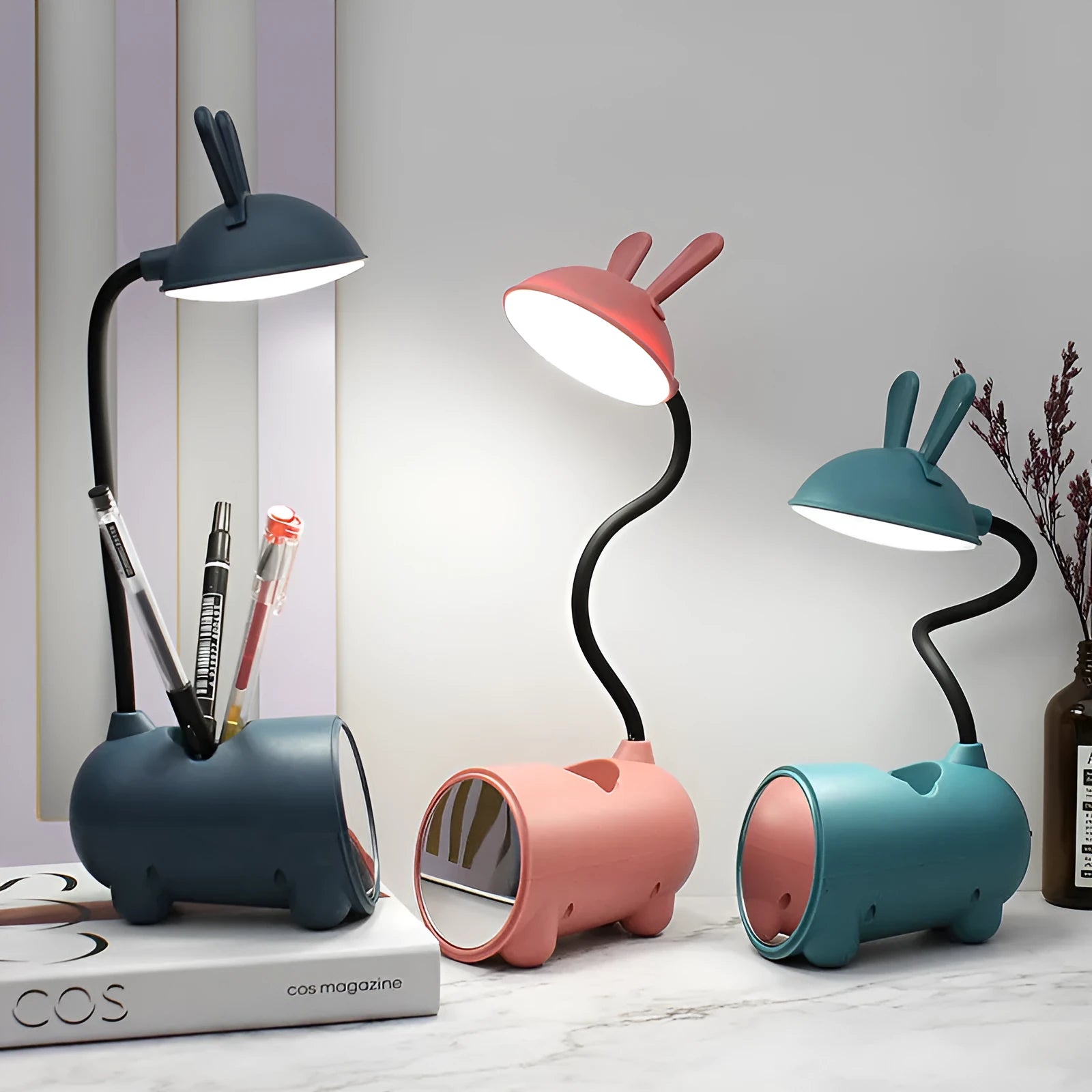 Modern green plastic USB table lamp with a long built-in pen holder on a wooden desk.