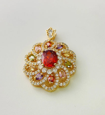 Close-up of a women's gold-coloured flower pendant necklace with a bright zircon stone centre.