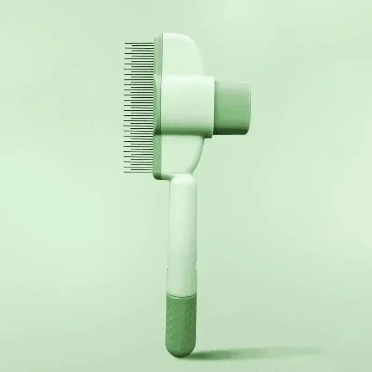 Green pet grooming brush with detachable hair collection tray and soft silicone handle