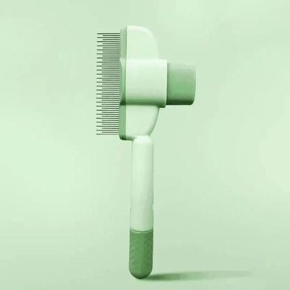 Green pet grooming brush with detachable hair collection tray and soft silicone handle