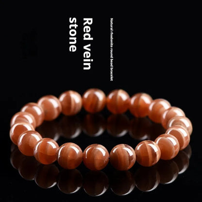 Natural old mine rhodochrosite bracelet with round geometric beads showing manganese spar colour variations
