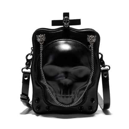 Black mini square messenger bag with embossed skull design, metal chains, and crossbody strap