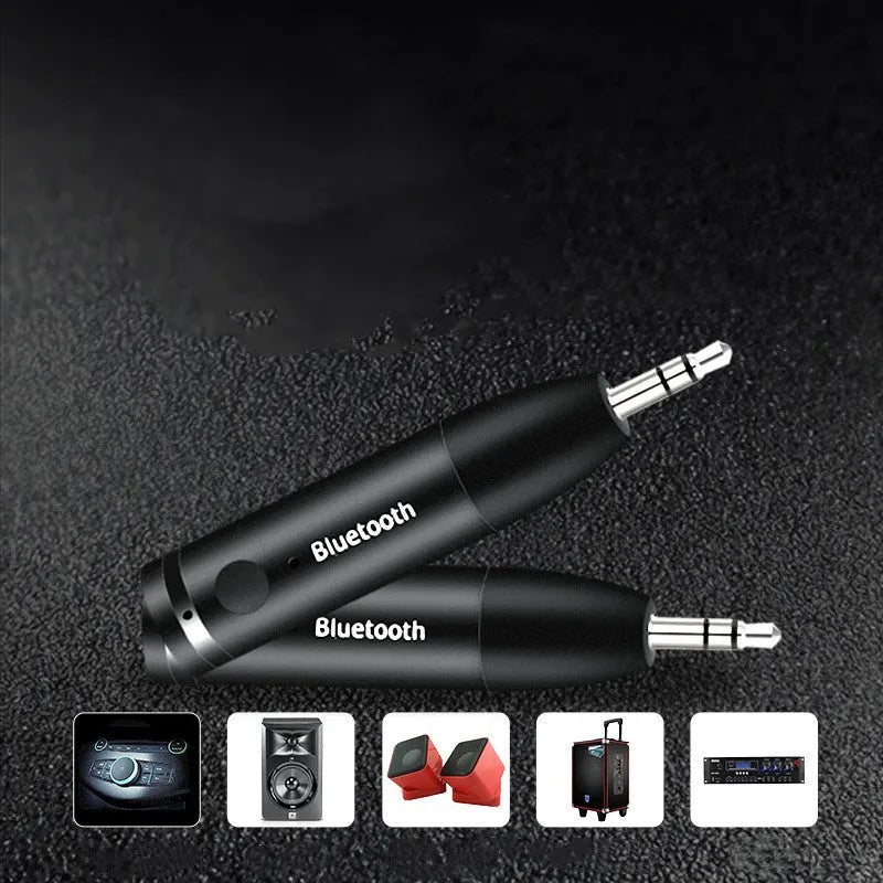 Compact black Bluetooth audio receiver with 3.5mm jack for car stereo and USB cable.