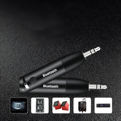 Compact black Bluetooth audio receiver with 3.5mm jack for car stereo and USB cable.