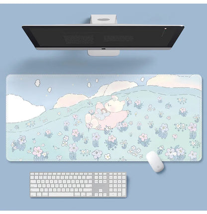 Large floral pattern mouse pad on a wooden desk with a computer mouse.