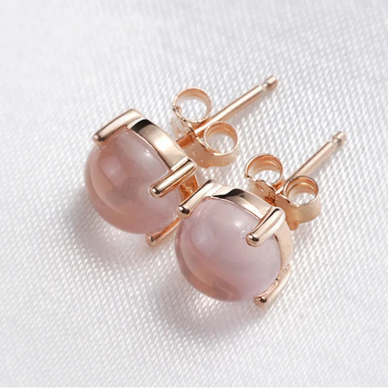 Women's drop-shaped stud earrings with synthetic rose quartz inlay and rose gold plating.