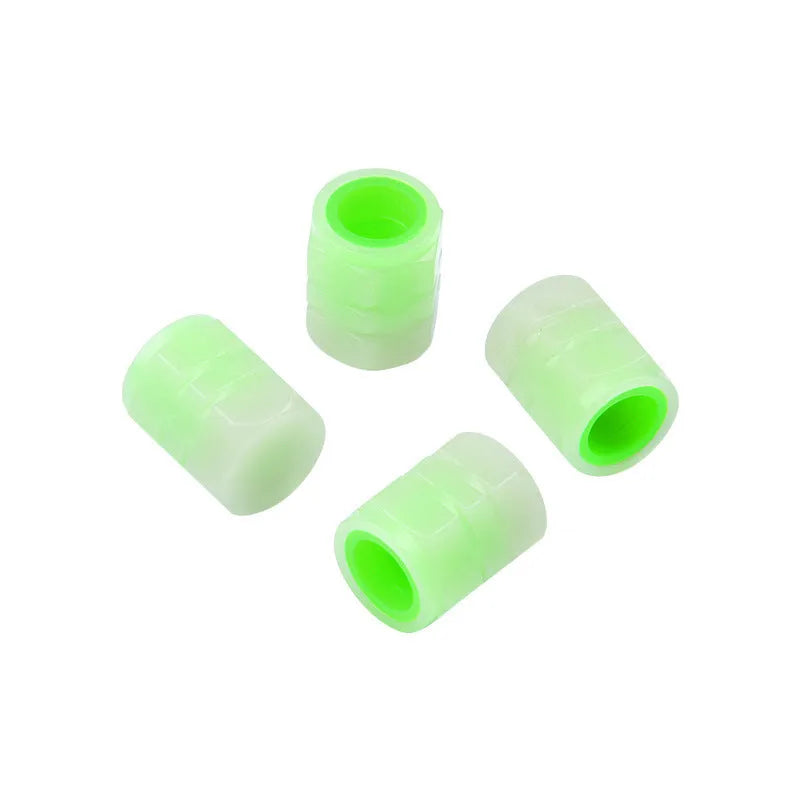 Set of four luminous rubber valve caps for car tyres showing glow effect