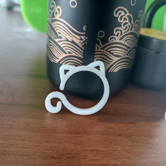 Red cat-shaped plastic gardening clip securing plant stem, showing 3cm length and decorative feline design