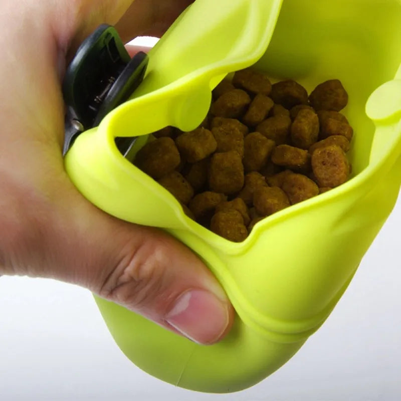 Black silicone dog training treat pouch with clip and magnetic closure shown attached to a belt.