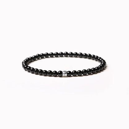 Geometric unisex bracelet with small Obsidian, blue San, and textured black agate beads.