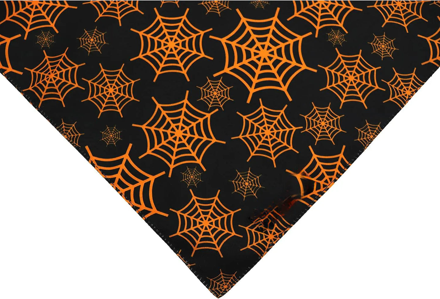 Black and orange reversible Halloween dog bandana with pumpkin and spider web print laid flat
