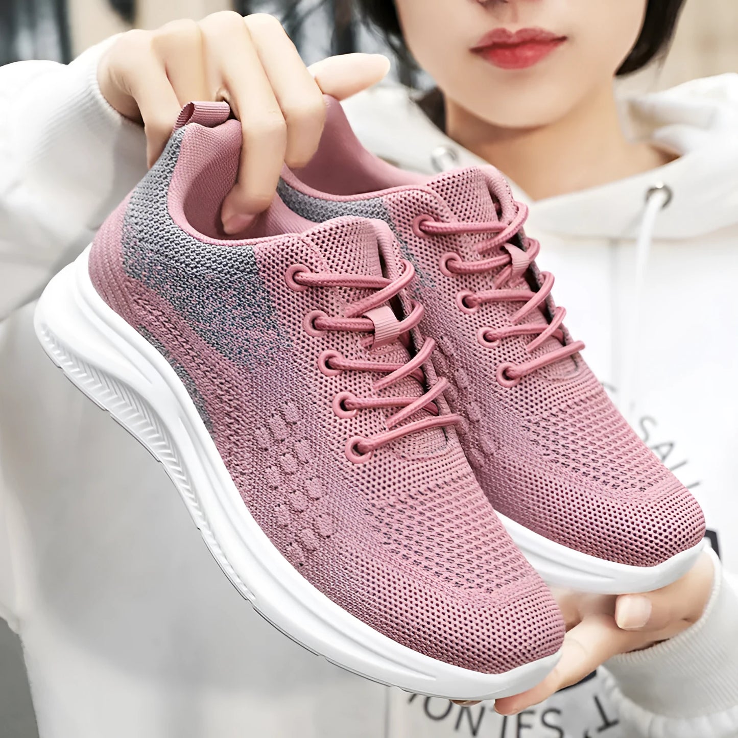 Women's black mesh sneakers with round toe and lace-up design showing breathable construction