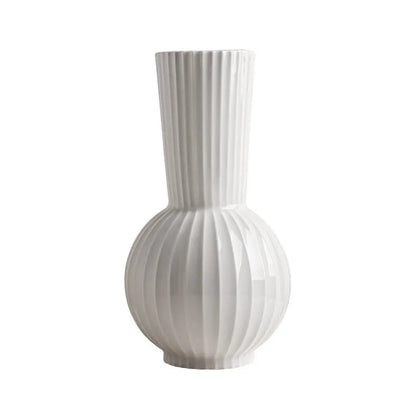 White ceramic ball-shaped vase with striped pattern, shown in small and large sizes with orchid arrangements