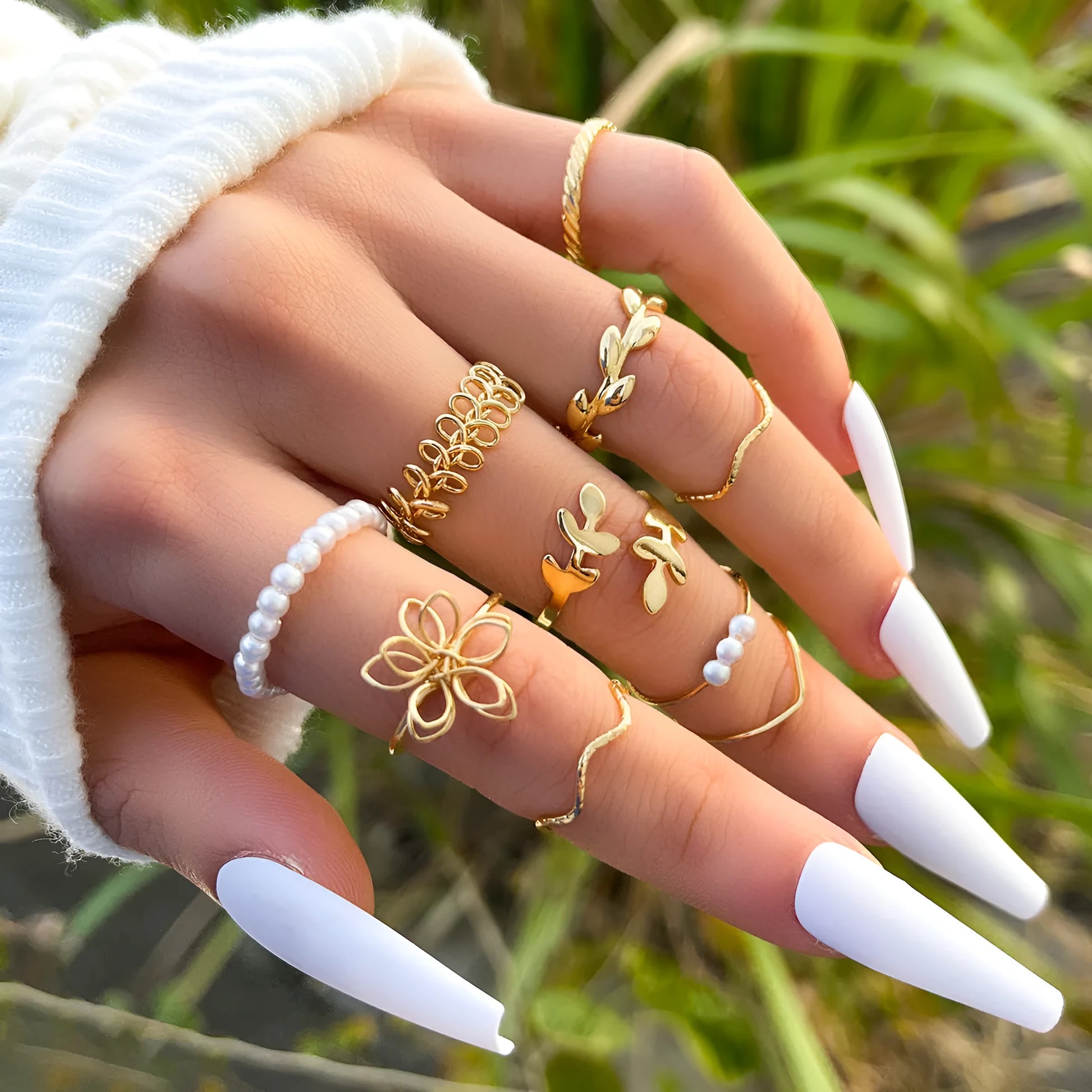 Women's gold openwork flower ring set showing detailed floral cut-out pattern and glossy electroplated finish