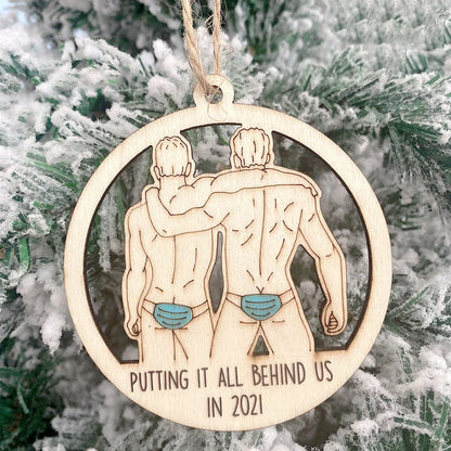 Wooden hollowed-out Christmas ornament with intricate snowman and deer laser-cut design