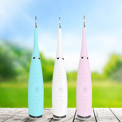 Ultrasonic tartar remover in white, pink, blue, and black colors for effective dental care at home